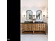 Elegant bathroom with a double vanity, marble counters, stylish lighting, and decor at 2212 Oxford Hills Dr, Raleigh, NC 27608