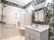 Modern bathroom boasts decorative wallpaper, a glass shower, and sleek fixtures at 2212 Oxford Hills Dr, Raleigh, NC 27608