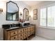 Elegant bathroom with double vanity, marble counters, and stylish lighting fixtures at 2212 Oxford Hills Dr, Raleigh, NC 27608