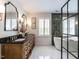 Luxurious bathroom featuring double vanities, marble floors, and a modern soaking tub at 2212 Oxford Hills Dr, Raleigh, NC 27608