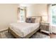 Cozy bedroom with natural light, a plush queen-sized bed, and a stylish area rug at 2212 Oxford Hills Dr, Raleigh, NC 27608