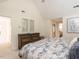 Relaxing bedroom featuring blue and white bedding, vaulted ceilings, and stylish decor at 2212 Oxford Hills Dr, Raleigh, NC 27608