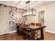 Dining room featuring stylish wallpaper, modern lighting, and connection to the kitchen at 2212 Oxford Hills Dr, Raleigh, NC 27608