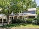 Charming brick home with a large tree in front and a covered carport at 2212 Oxford Hills Dr, Raleigh, NC 27608