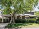 Charming brick home with a large tree in front and a covered carport at 2212 Oxford Hills Dr, Raleigh, NC 27608