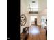 Bright foyer with hardwood floors, wine rack, and view of the staircase and open floor plan at 2212 Oxford Hills Dr, Raleigh, NC 27608