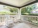 Inviting front porch with white rocking chairs and lush greenery provides a relaxing outdoor space at 2212 Oxford Hills Dr, Raleigh, NC 27608