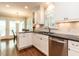 Bright kitchen features white cabinets, granite countertops, stainless steel appliances, and hardwood floors at 2212 Oxford Hills Dr, Raleigh, NC 27608