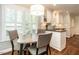 Kitchen with an eat-in area featuring a large window, natural light, and classic white cabinetry at 2212 Oxford Hills Dr, Raleigh, NC 27608