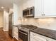 Stylish kitchen with granite counters, stainless appliances, and white cabinetry at 2212 Oxford Hills Dr, Raleigh, NC 27608