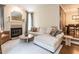 Bright living room with fireplace, plush seating, and seamless flow into the dining area at 2212 Oxford Hills Dr, Raleigh, NC 27608