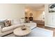 Open-concept living room with plush seating, hardwood floors, and seamless flow into dining area at 2212 Oxford Hills Dr, Raleigh, NC 27608