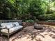 Back patio with brick flooring, a modern firepit, and a comfortable seating area at 2212 Oxford Hills Dr, Raleigh, NC 27608