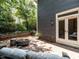 Back patio with a modern firepit, outdoor grill, and french doors leading inside at 2212 Oxford Hills Dr, Raleigh, NC 27608