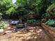 Private backyard patio featuring a custom brick border and a stylish fire pit at 2212 Oxford Hills Dr, Raleigh, NC 27608