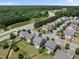 An aerial view captures a residential neighborhood near a tranquil pond, showcasing community and natural beauty at 2412 Averon Dr, Fuquay Varina, NC 27526