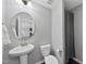 Bathroom with pedestal sink, toilet, and grey shower curtain at 2412 Averon Dr, Fuquay Varina, NC 27526