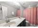 Clean bathroom with double sink vanity, large mirror, and shower with a decorative curtain at 2412 Averon Dr, Fuquay Varina, NC 27526