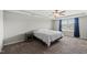 Comfortable bedroom with ceiling fan, tray ceiling, and view of the front yard at 2412 Averon Dr, Fuquay Varina, NC 27526