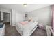 Comfortable bedroom featuring full bed, nightstand, vanity, bright window, and ample storage at 2412 Averon Dr, Fuquay Varina, NC 27526