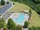 An aerial view reveals a sparkling community pool with ample seating, perfect for relaxation and neighborhood gatherings at 2412 Averon Dr, Fuquay Varina, NC 27526