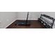 Close-up of exercise room featuring hardwood floors, a treadmill, and weights at 2412 Averon Dr, Fuquay Varina, NC 27526