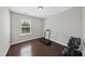 Bright exercise room with dark hardwood floors, a treadmill, and weights at 2412 Averon Dr, Fuquay Varina, NC 27526