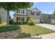Inviting two-story home with mature landscaping, attached garage, and a covered front porch at 2412 Averon Dr, Fuquay Varina, NC 27526