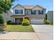 Charming two-story home with well-manicured lawn and a two car garage at 2412 Averon Dr, Fuquay Varina, NC 27526