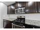 Modern kitchen features granite countertops, stainless steel appliances, and white subway tile backsplash at 2412 Averon Dr, Fuquay Varina, NC 27526