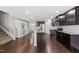 Open-concept kitchen with dark wood cabinets, granite countertops, and stainless steel appliances at 2412 Averon Dr, Fuquay Varina, NC 27526