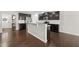 Open kitchen with a center island, stainless steel appliances, and dark wood cabinetry at 2412 Averon Dr, Fuquay Varina, NC 27526