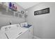 This laundry room is equipped with a washing machine, dryer, and clever wall art at 2412 Averon Dr, Fuquay Varina, NC 27526