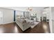 Living room featuring a plush grey sectional, hardwood floors, and great natural light at 2412 Averon Dr, Fuquay Varina, NC 27526