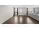 Bright living room with dark hardwood floors, natural light, and blue curtains at 2412 Averon Dr, Fuquay Varina, NC 27526