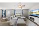 Living room with a ceiling fan, large sectional sofa, television, and fireplace at 2412 Averon Dr, Fuquay Varina, NC 27526