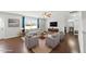 Inviting living room features hardwood floors, a ceiling fan, a sofa, and four armchairs at 2412 Averon Dr, Fuquay Varina, NC 27526