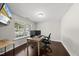Bright home office featuring hardwood floors, a large window, and a modern desk setup at 2412 Averon Dr, Fuquay Varina, NC 27526