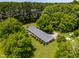A captivating aerial view of a beautiful property nestled among lush, mature trees and landscaping at 250 Dixon Rd, Graham, NC 27253
