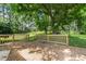 Relaxing on this wooden deck, framed by greenery, promises a tranquil outdoor experience at 250 Dixon Rd, Graham, NC 27253