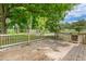 Wooden deck overlooking a lush backyard with mature trees, creating a peaceful outdoor setting at 250 Dixon Rd, Graham, NC 27253