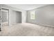 Spacious bedroom boasts plush carpet, a sunlit window, and closet, offering comfort and practicality at 250 Dixon Rd, Graham, NC 27253