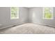 Well-lit bedroom features two windows, providing ample natural light and ventilation at 250 Dixon Rd, Graham, NC 27253