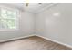 Comfortable bedroom with laminate flooring, a large window, and ample space for relaxation and personalization at 250 Dixon Rd, Graham, NC 27253