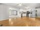 Open floor plan with a kitchen featuring white cabinets, stainless appliances, and a seamless flow to the living area at 250 Dixon Rd, Graham, NC 27253
