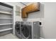 Functional laundry room equipped with washer, dryer, cabinetry, and shelving for convenience at 250 Dixon Rd, Graham, NC 27253