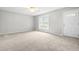 Bright, carpeted living room with a large window and ample natural light, creating a welcoming atmosphere at 250 Dixon Rd, Graham, NC 27253