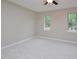 Spacious bedroom with carpet, ceiling fan, and natural light from the windows at 2708 Sundial Cir, Durham, NC 27704