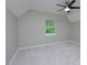 Bedroom featuring neutral carpet, window, and sloped ceiling at 2708 Sundial Cir, Durham, NC 27704