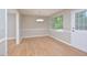 Bright dining room featuring wood floors, chair rail, modern lighting, and natural light at 2708 Sundial Cir, Durham, NC 27704